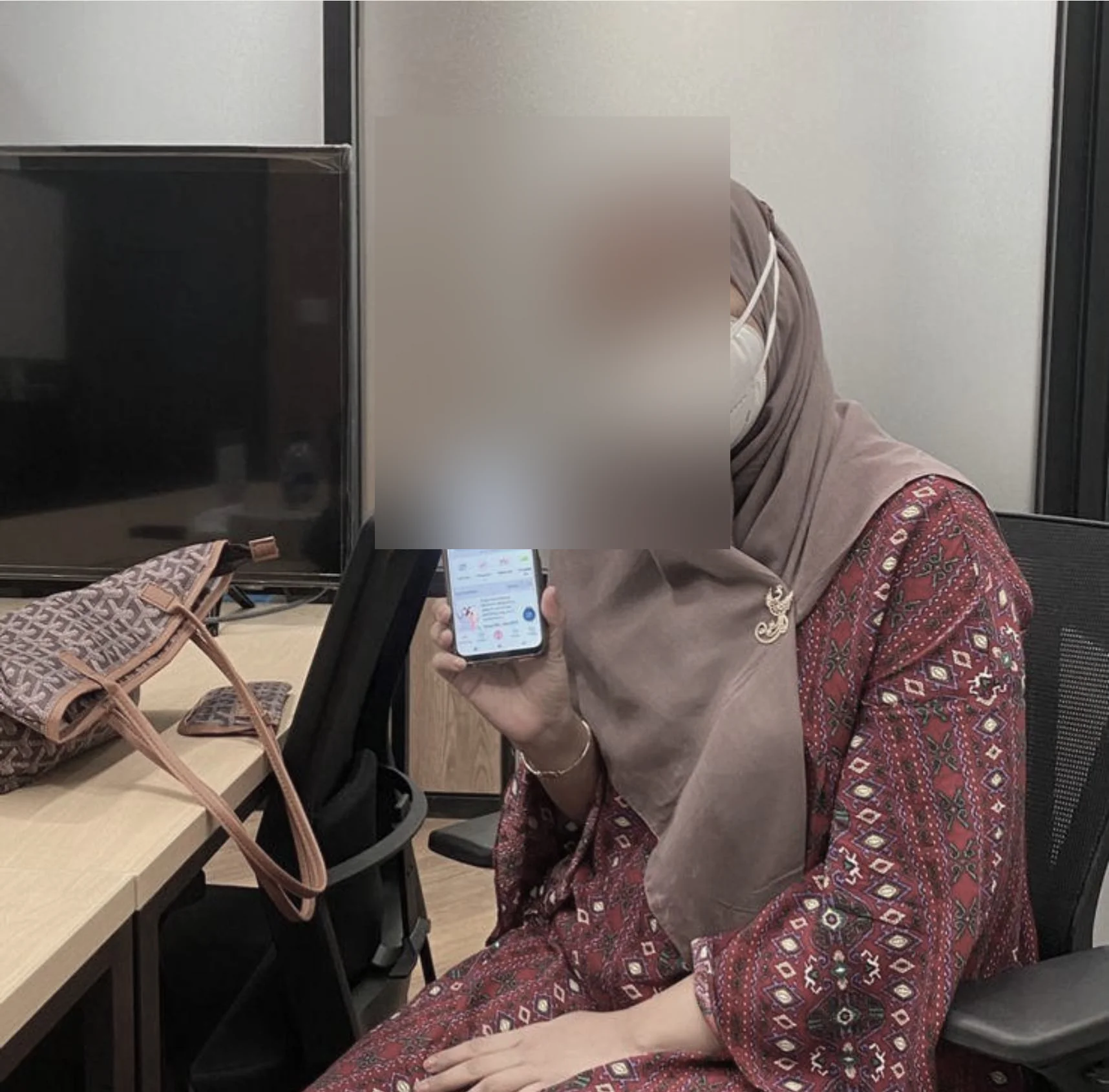 Photo from a moderated usability testing session, participant's face blurred for privacy